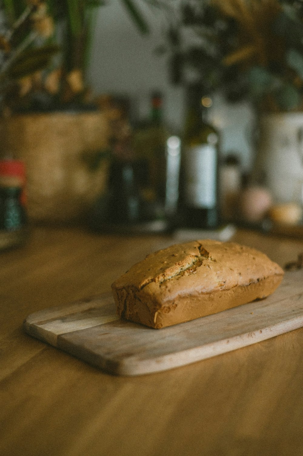 a loaf of bread sitting on top of a wooden cutting board