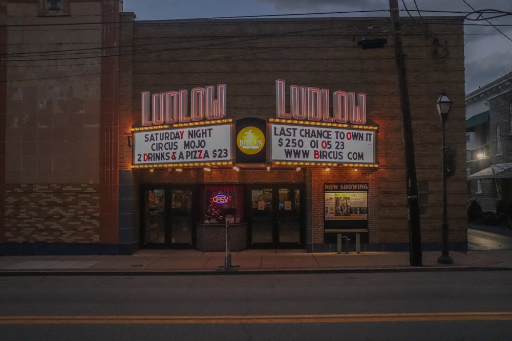 a theater marquee on the corner of a street