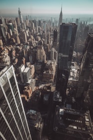 An aerial view of a bustling cityscape highlighting properties listed by serhant.