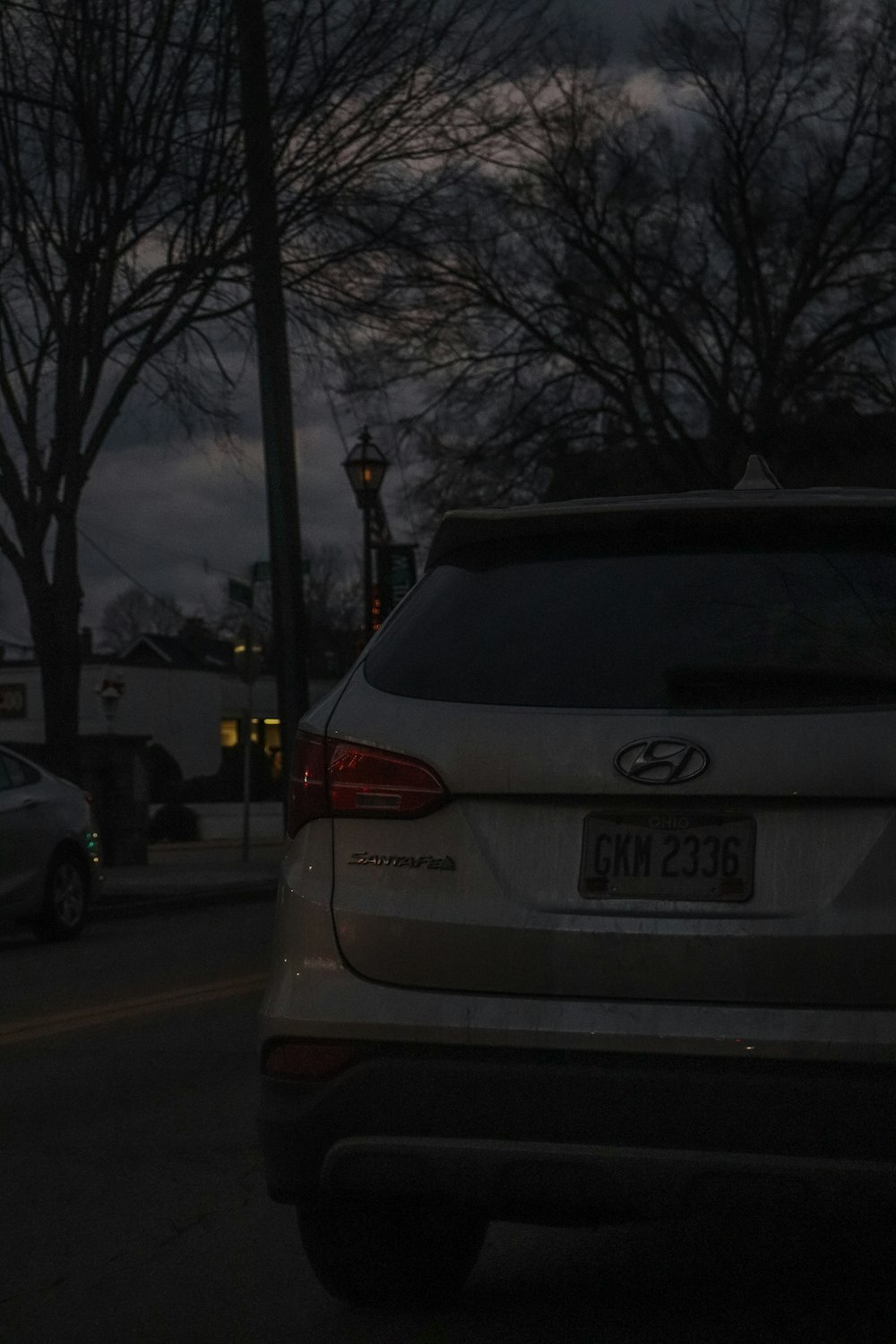 a car parked on the side of the road at night