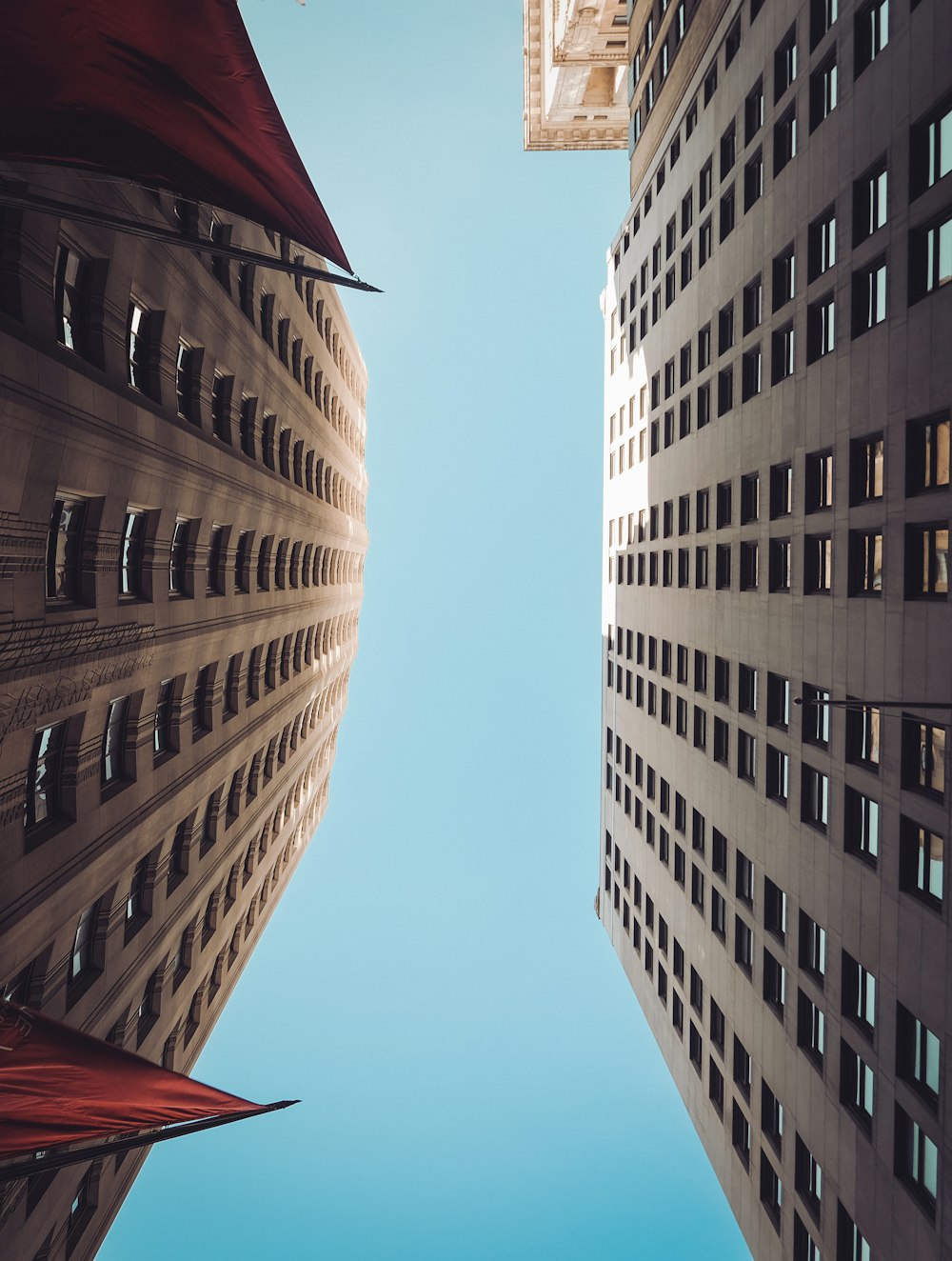 looking up at two tall buildings in a city