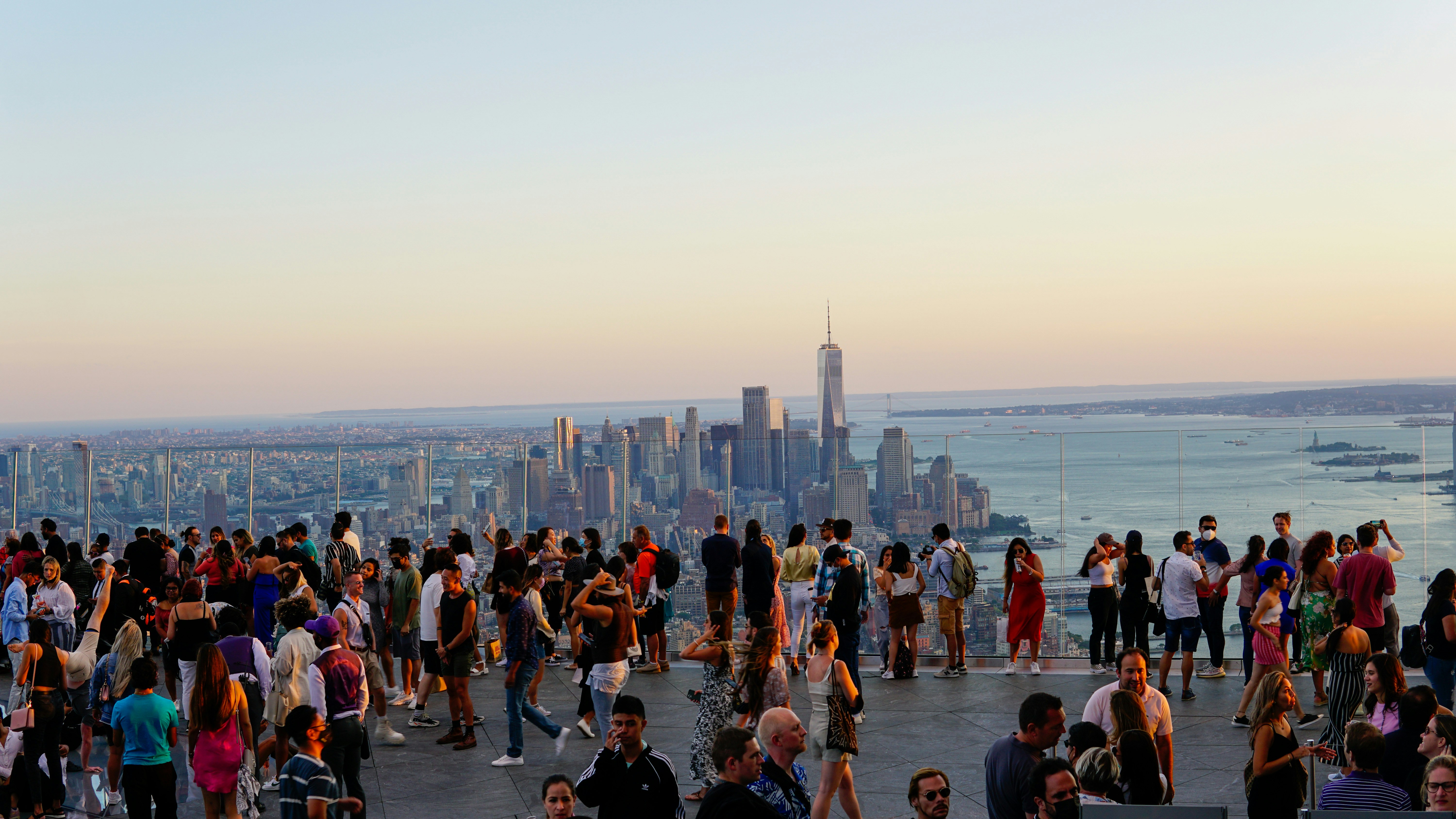 a large group of people standing on top of a building