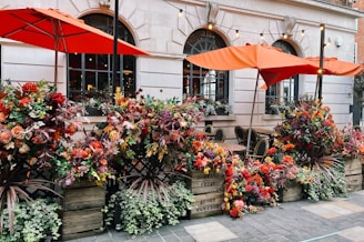 A vibrant outdoor seating area surrounded by flowers.