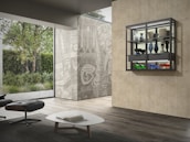 Elegant interior shot of the estate’s minimalist lounge with dark forest green walls and gold accents.