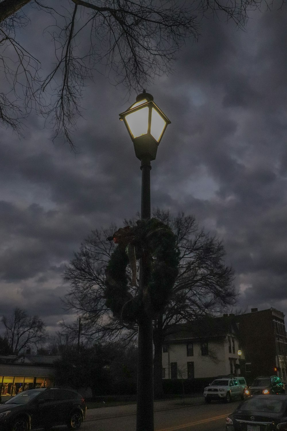 a lamp post with a wreath on top of it