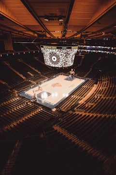 a basketball court in a large arena with fans