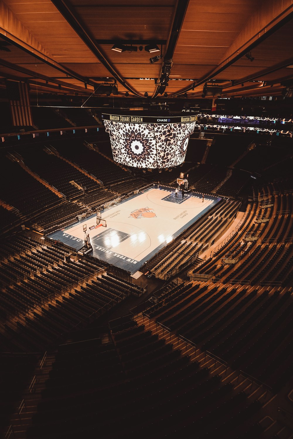 a basketball court in a large arena with fans