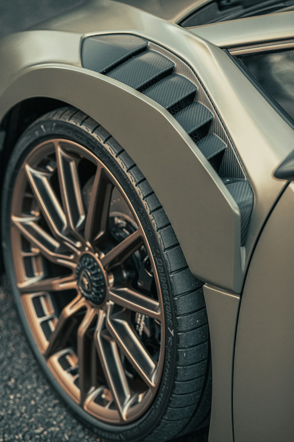 a close up of a shiny silver sports car