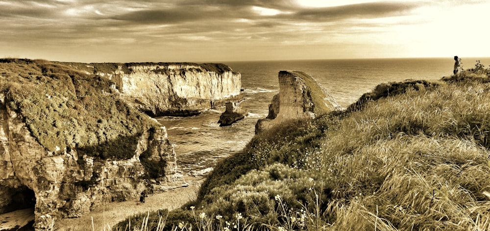 an old photo of a cliff by the ocean
