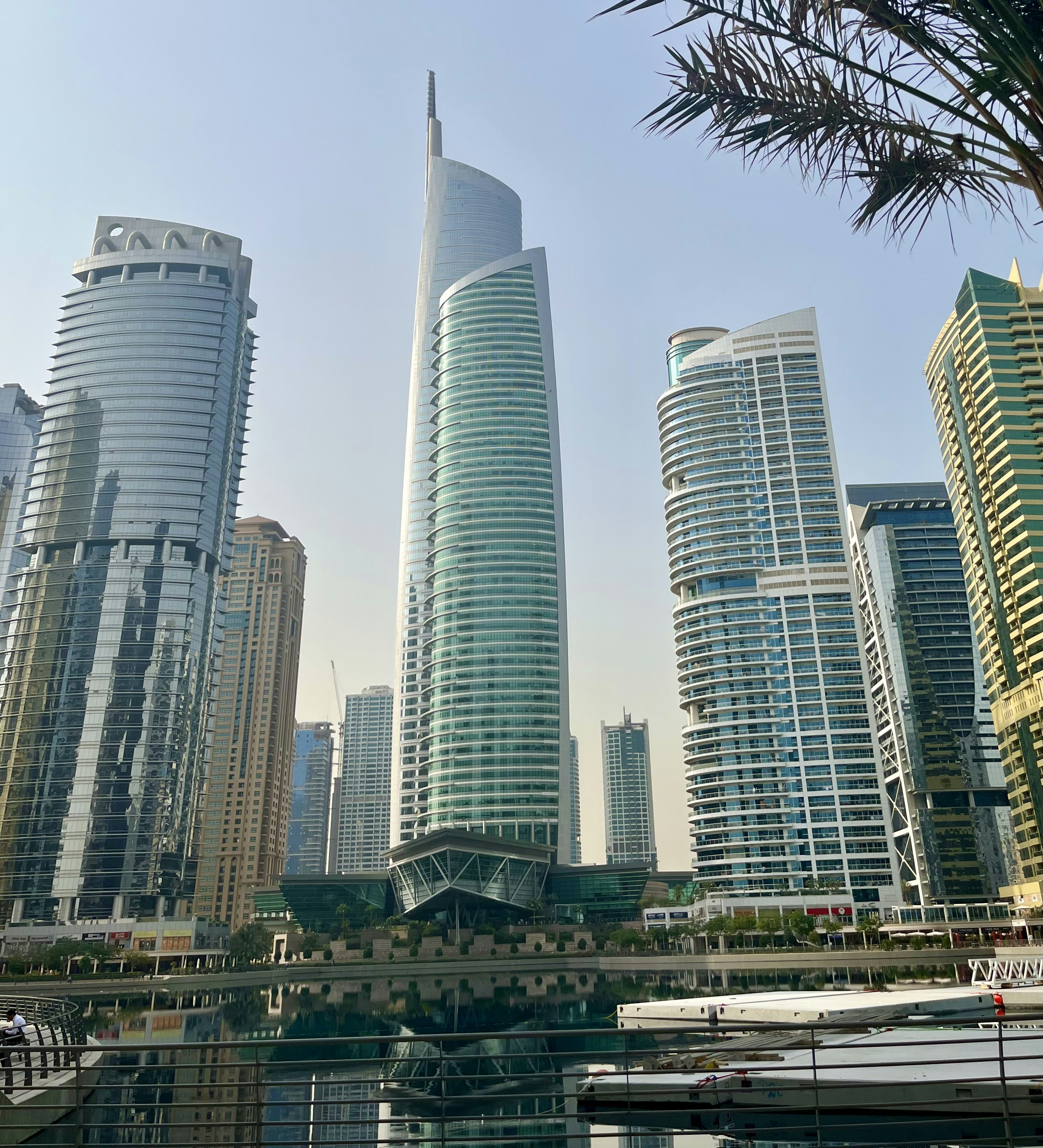 Modern glass office tower reflecting city skyline — corporate architecture, executive business environment