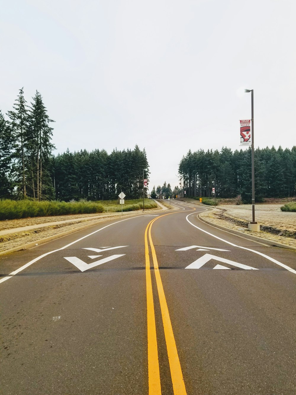 a road with two white arrows painted on it