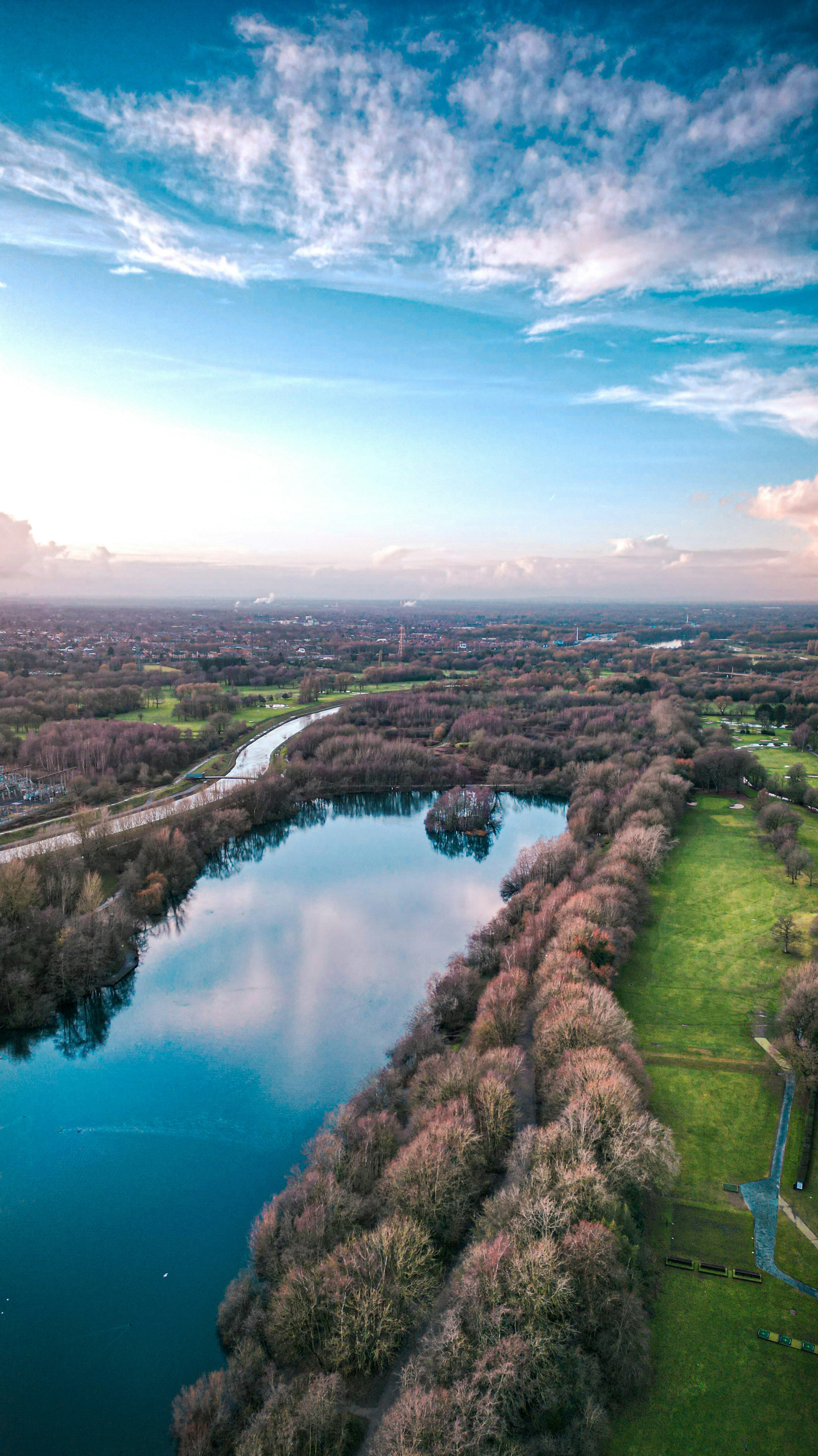 an aerial view of a lake surrounded by trees