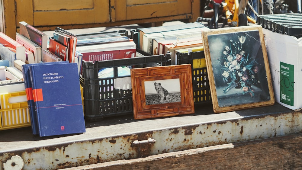 a bunch of picture frames sitting on top of a table