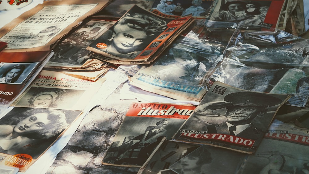 a table topped with lots of old movie posters