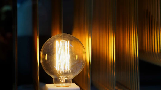 A warm-lit LED bulb glowing softly in a cozy room setting