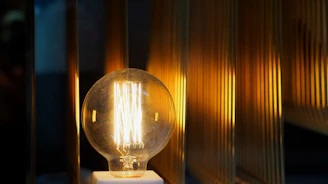 A warm-lit LED bulb glowing softly in a cozy room setting