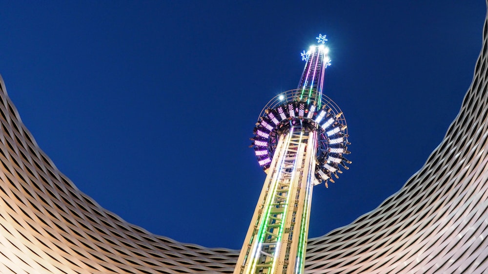 a very tall building with a ferris wheel on top of it