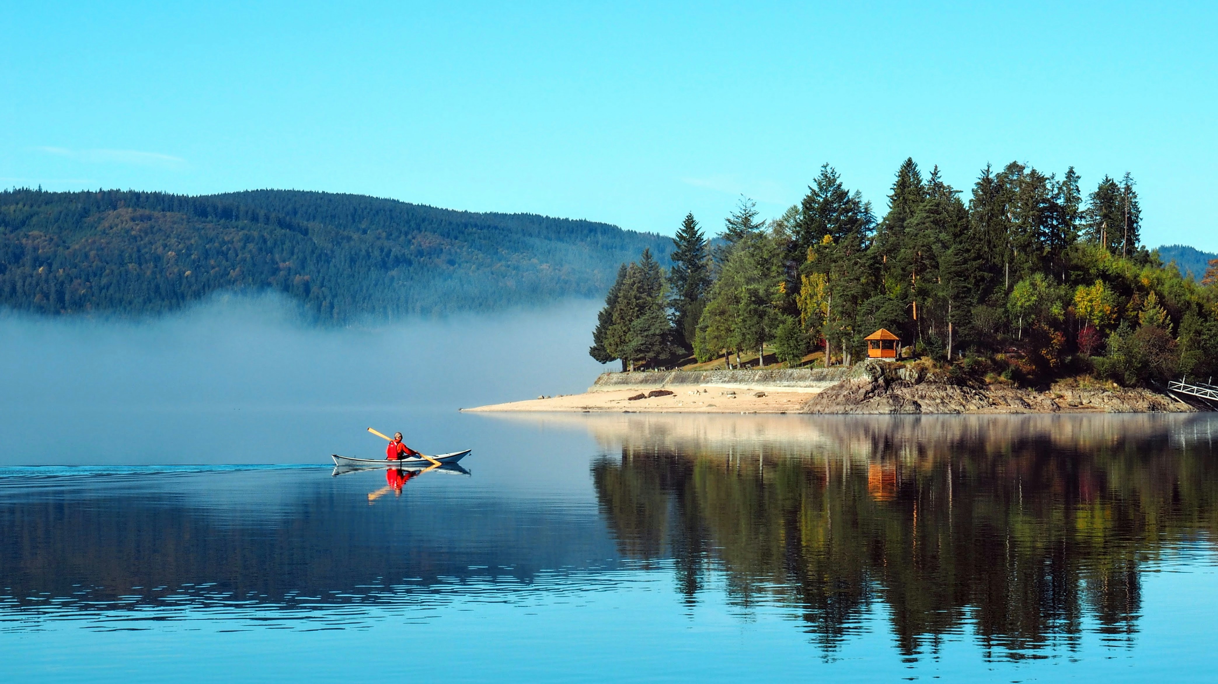 a person in a canoe paddling on a lake