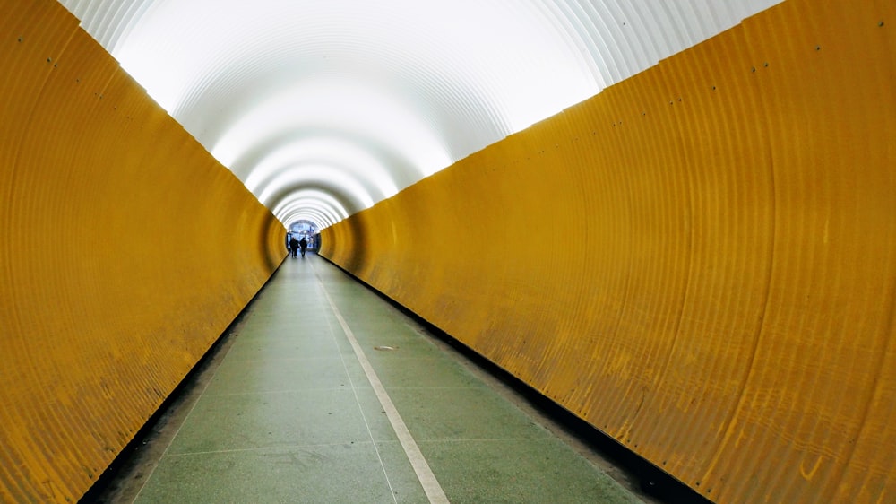 a long tunnel with yellow and white walls