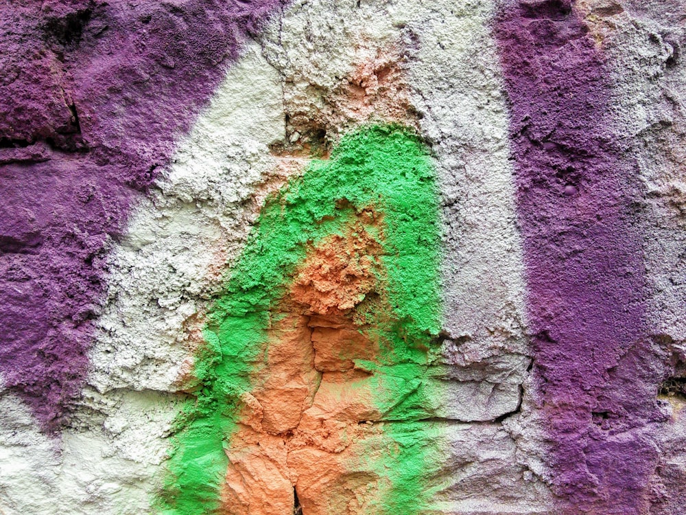 a close up of a colorful wall with a person painted on it