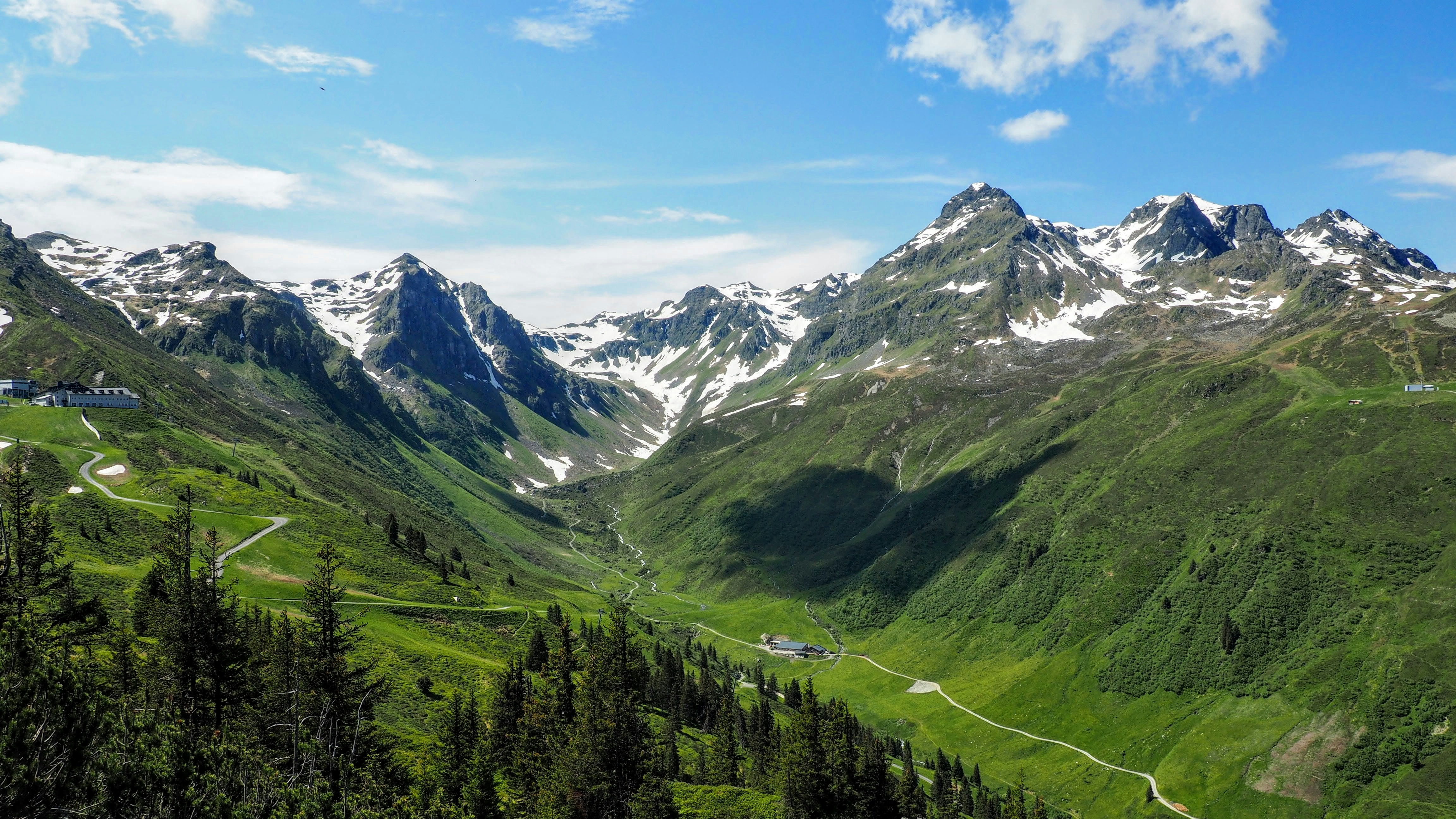 a scenic view of a valley with mountains in the background