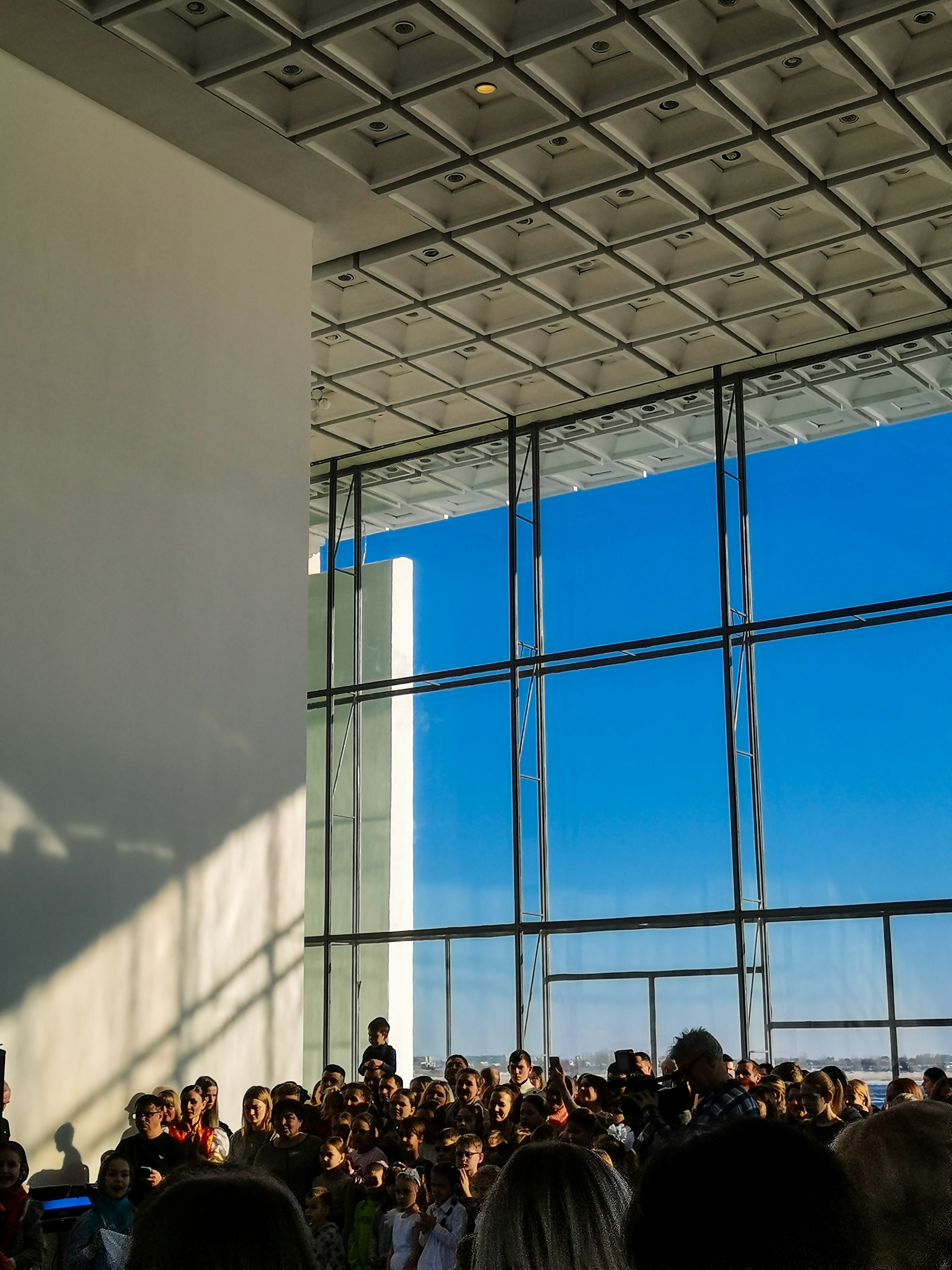 a large group of people standing in front of a window
