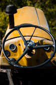 Close-up of a tractor dashboard displaying digital controls and gauges.