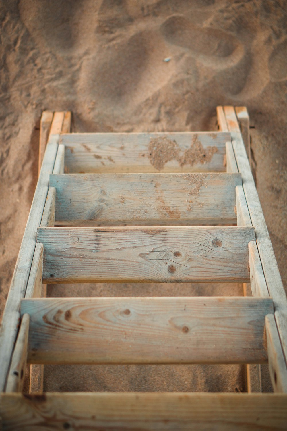 a close up of a wooden structure in the sand