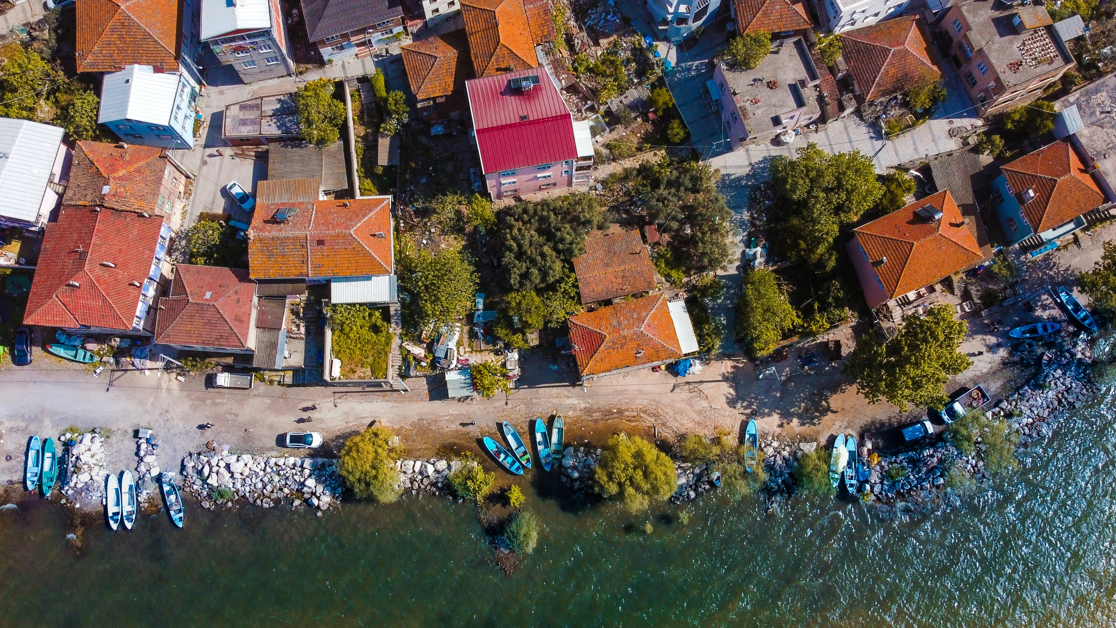 an aerial view of a small village with boats