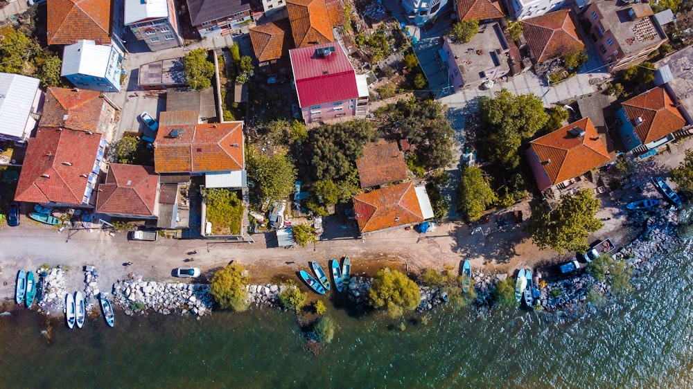 an aerial view of a small village with boats