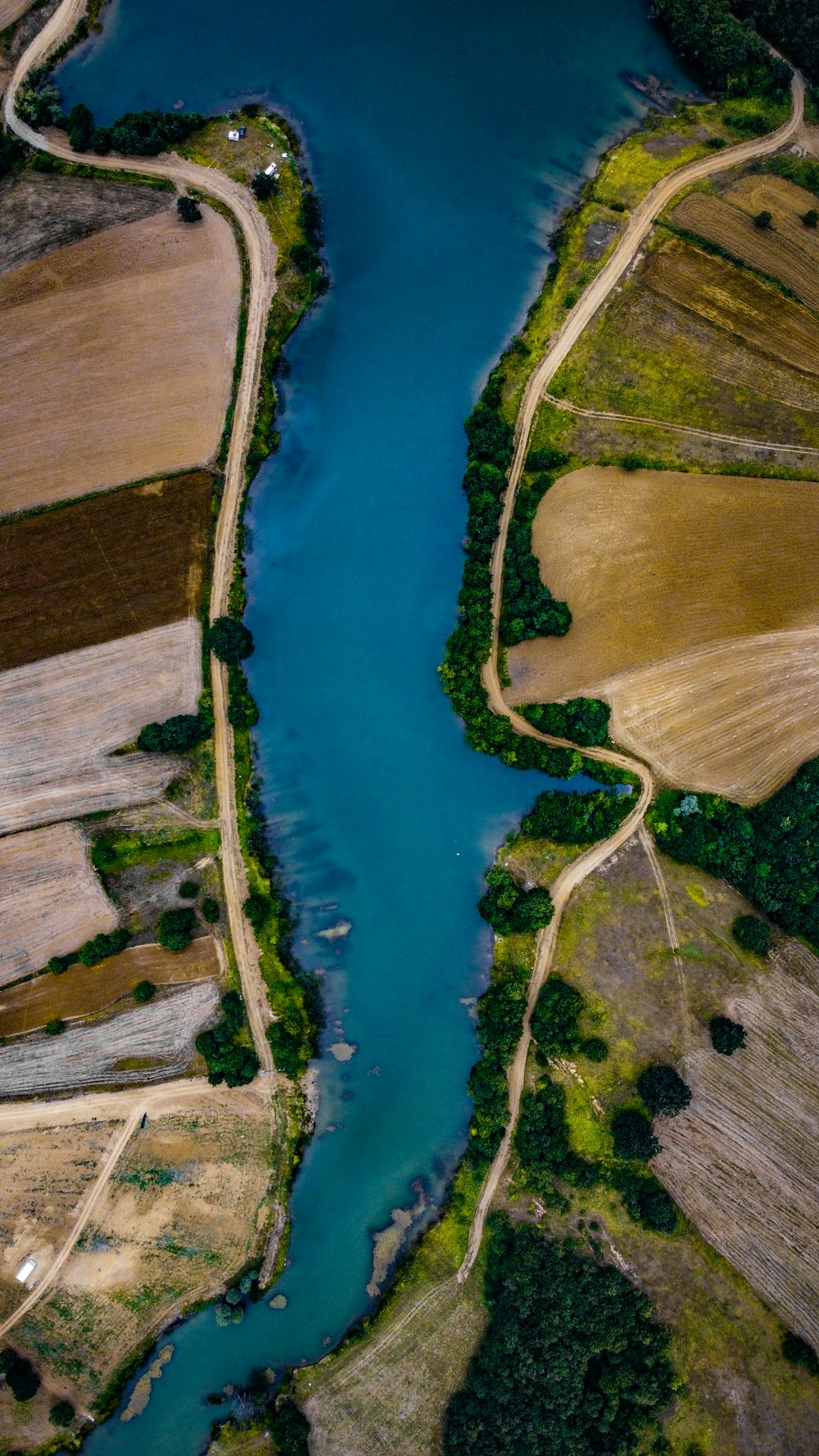 a river running through a lush green countryside