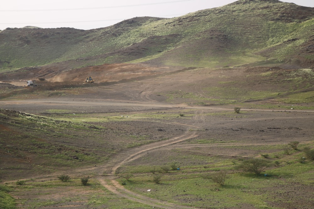 a dirt road in the middle of a hilly area