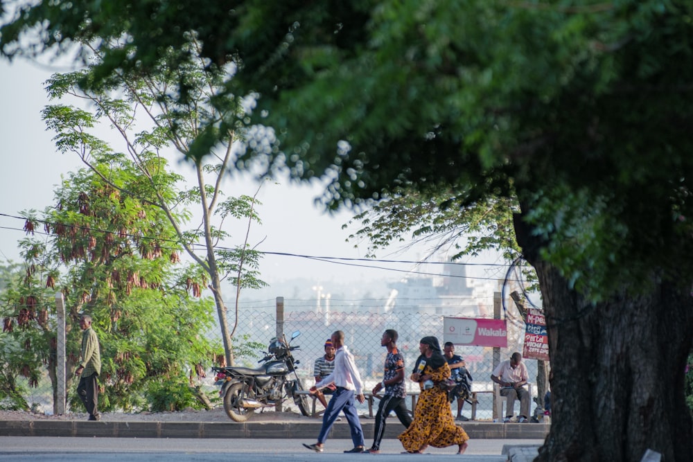 a group of people walking across a street