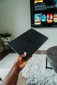 A cozy living room with a laptop and streaming on TV, showing smooth internet usage.