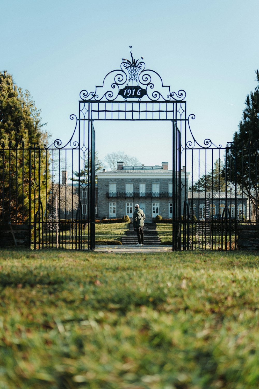 two people standing in front of a gate