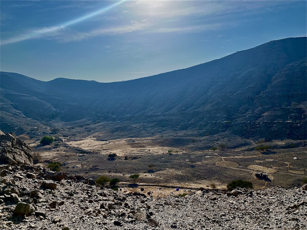 a view of a valley with mountains in the background