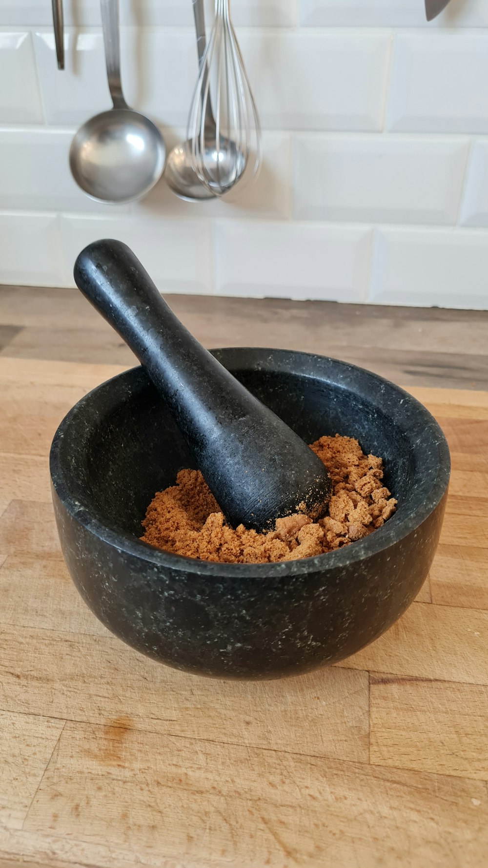 a wooden table with a black bowl of food