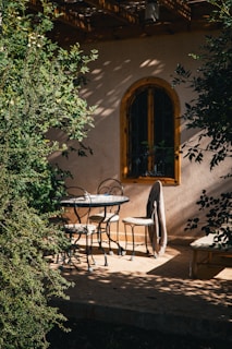 A charming 2-piece patio bistro set with a small table and two chairs, perfect for morning coffee.