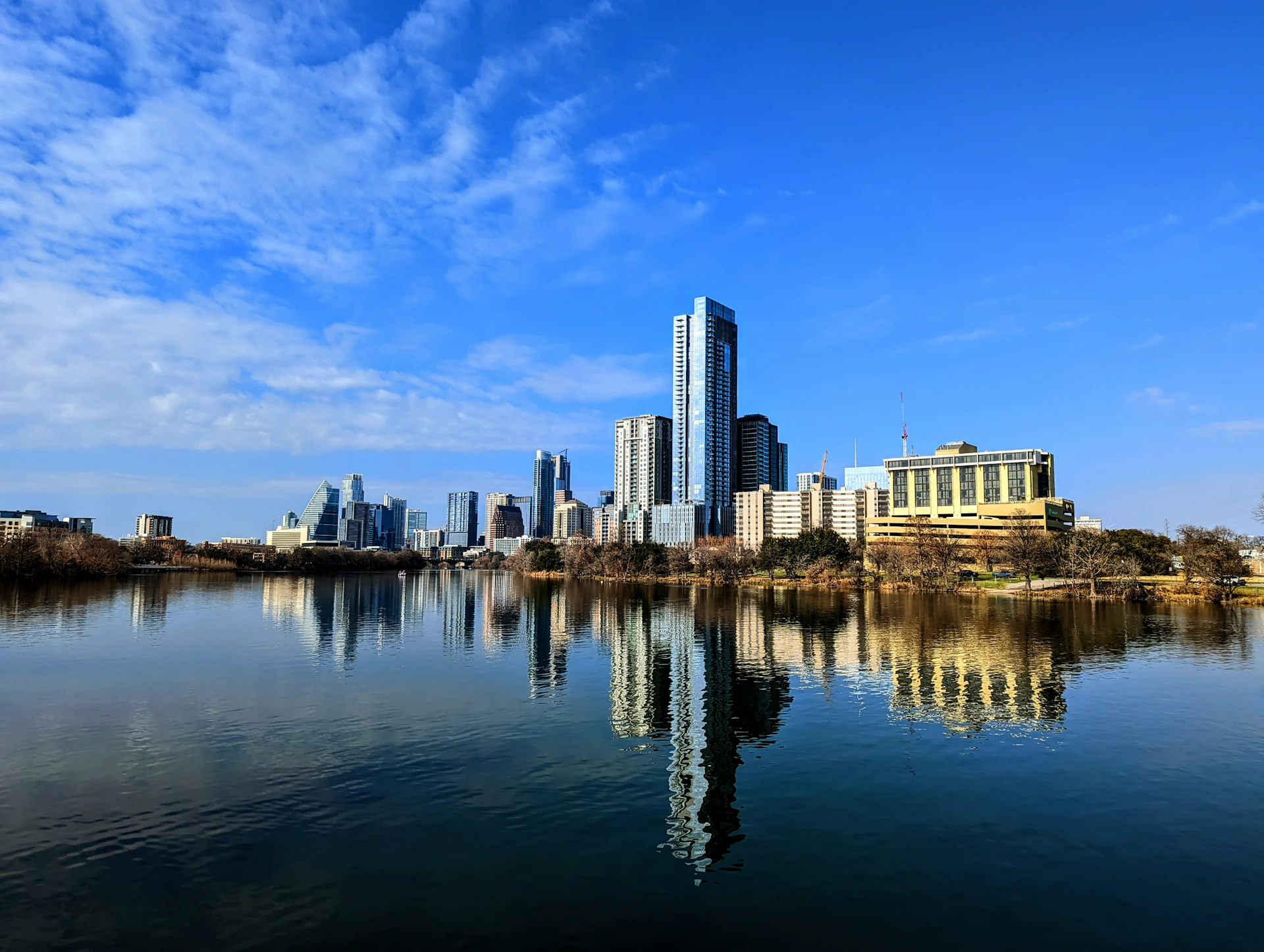 a large body of water with a city in the background