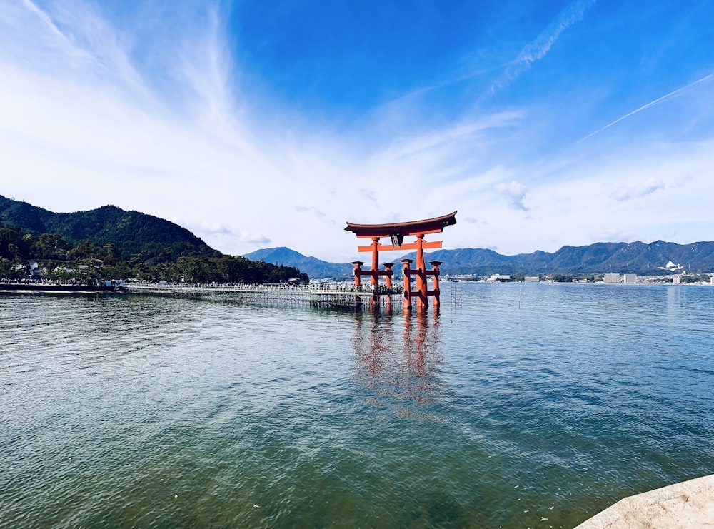 a large body of water with a small structure in the middle of it