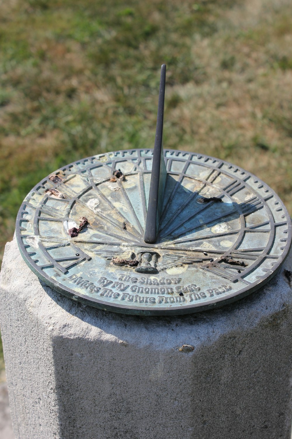 a sundial sitting on top of a cement block