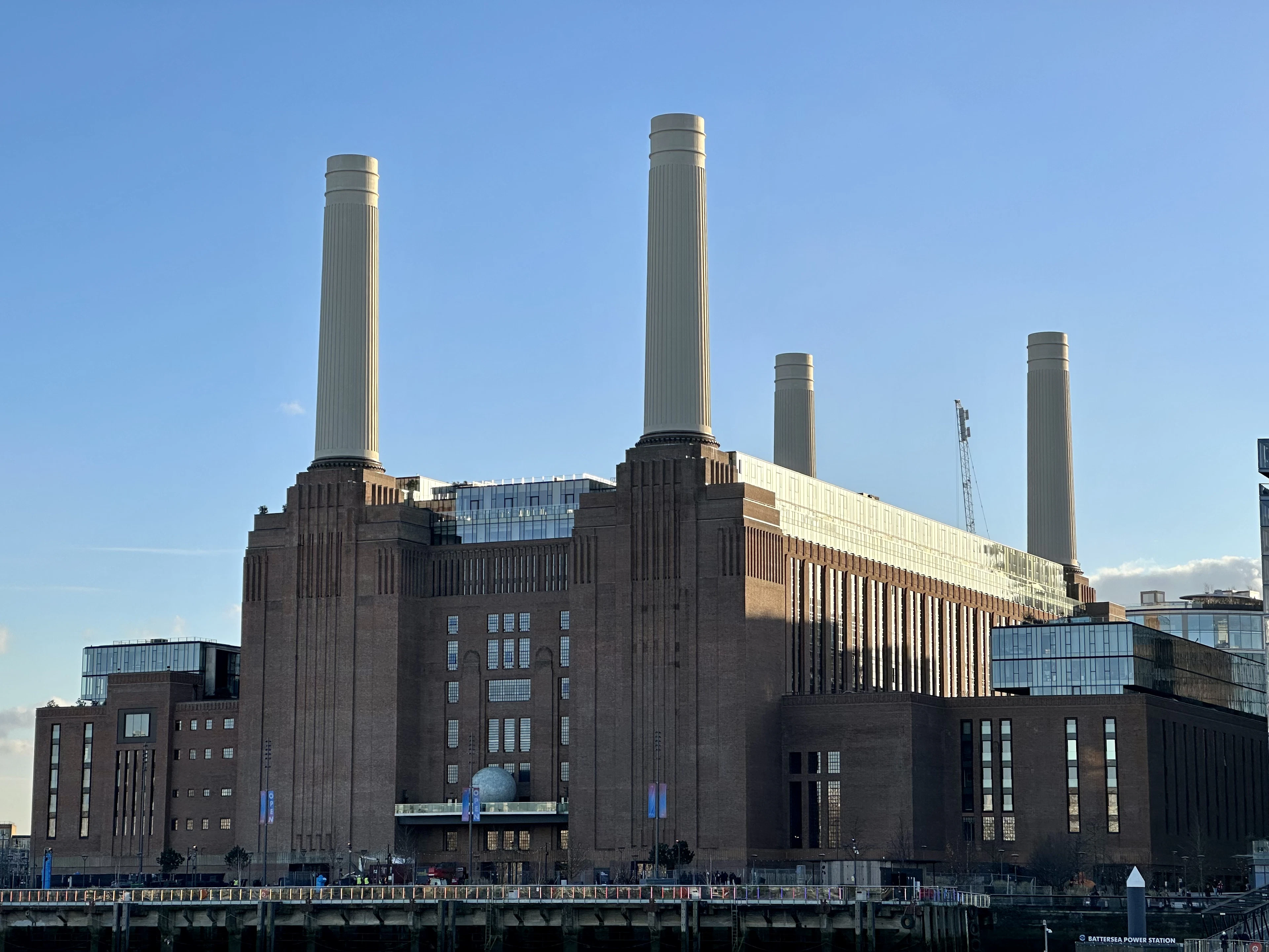 The four chimneys of Battersea Power Station against a blue sky