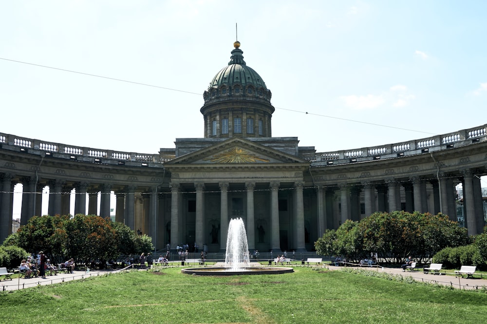 a large building with a fountain in front of it