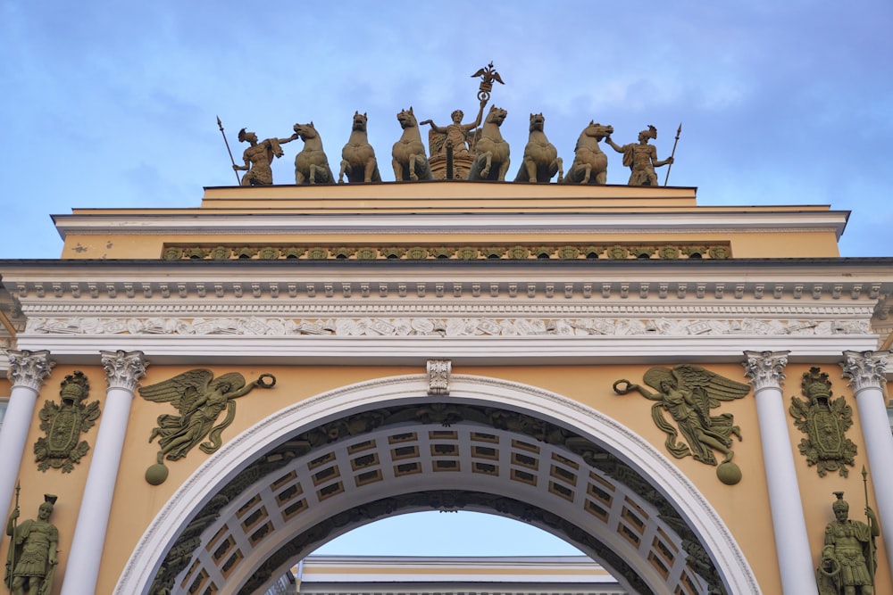 a large arch with statues on top of it