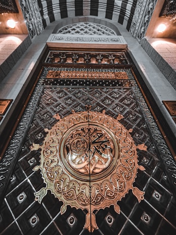 a large metal door with a clock on it