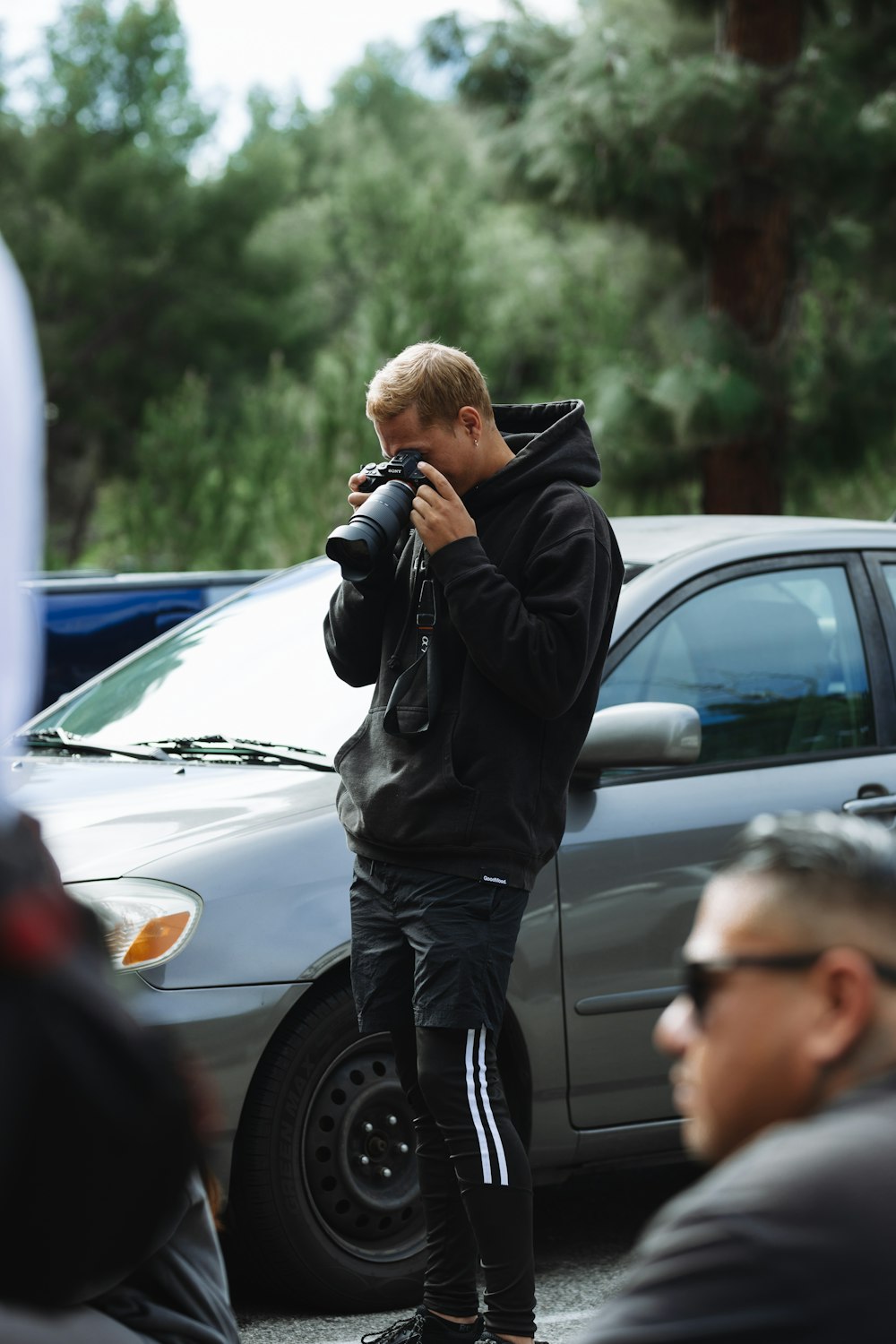 a man taking a picture of himself in a parking lot