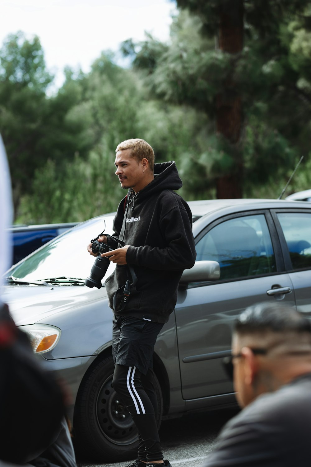 a man standing on a skateboard in a parking lot