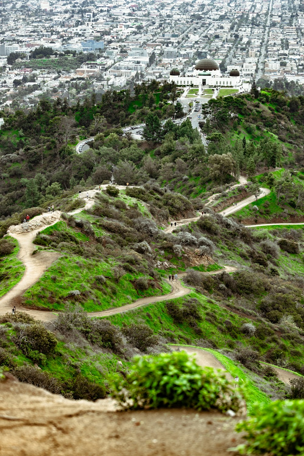 a scenic view of a city from a hill