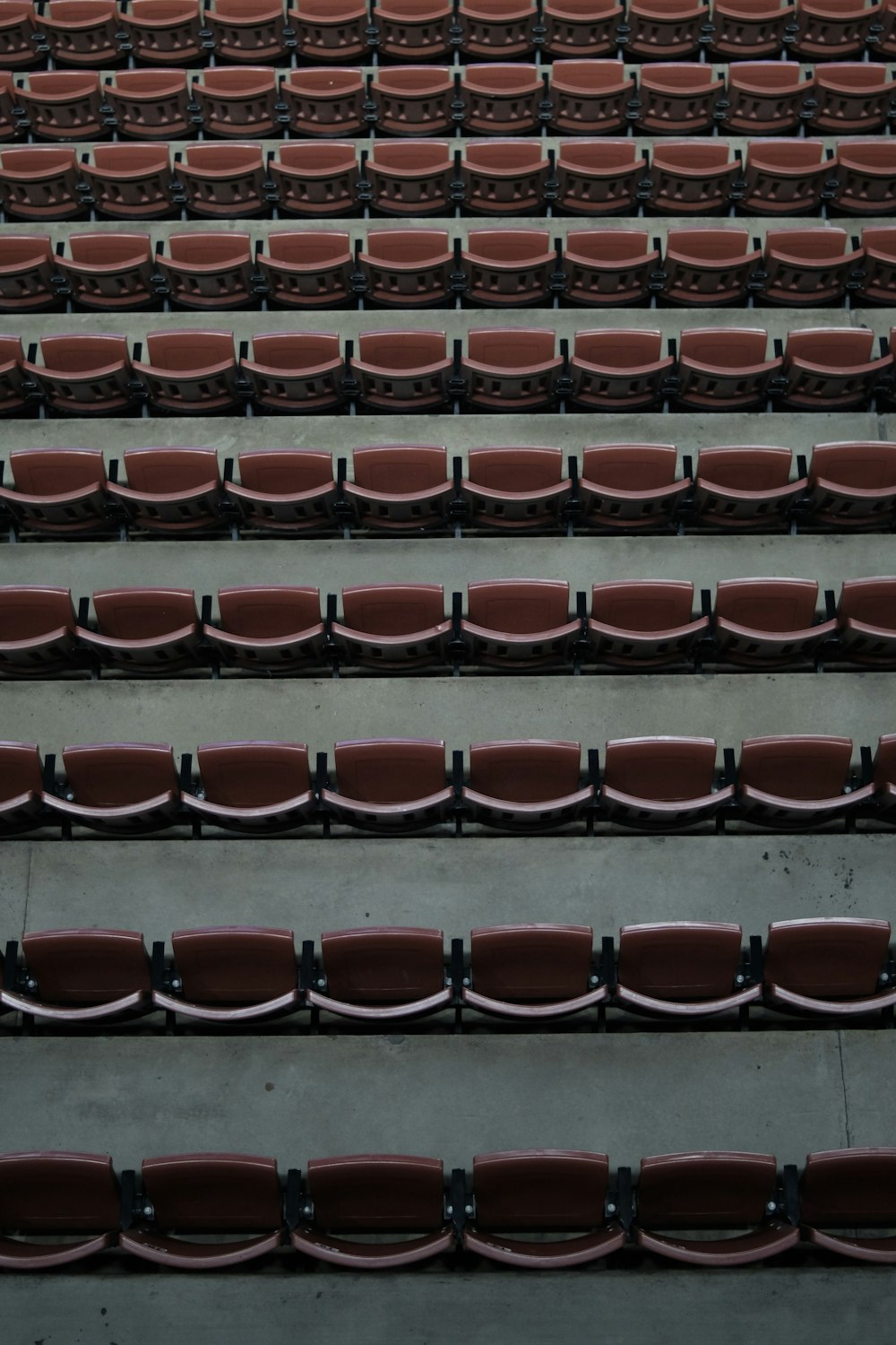 a row of red seats sitting next to each other