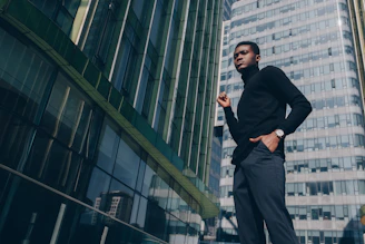 A vigilant security guard standing confidently outside a modern office building during sunset.